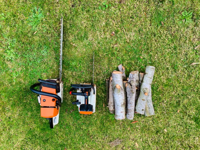 Two chainsaws sitting next to some firewood Trees were cut by Bayview Stump Removals before Stump Removals Melbourne